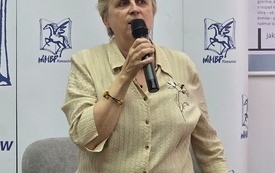 Profesorka przemawia do mikrofonu. 