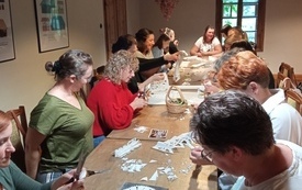 Warsztaty wycinanki i haftu dla bibliotekarek w przestrzeni muzealnej.