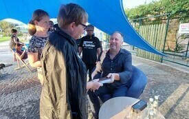 Gość spotkania podczas rozdawania autograf&oacute;w.