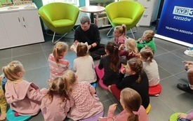 Mężczyzna z dziećmi podczas warsztat&oacute;w. 